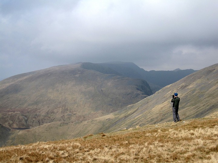 IMG_3200.JPG - Geoff taking photos from the top of Great Rigg.  Grisedale Tarn just visible bottom left